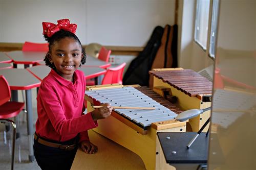 smiling girl on xylophone 