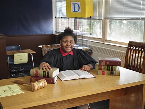 student at desk with law books 